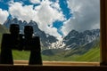 Binoculars lying on sill overlooking mountain. Royalty Free Stock Photo