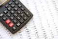 Big black calculator lies on financial statement and balance sheeet on desk of auditor close up. Concept of accounting and audit Royalty Free Stock Photo