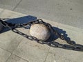 big and black chains near the sidewalk in the city.