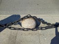 big and black chains near the sidewalk in the city.
