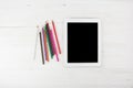 Big Black Empty Screen Smart Tablet Device Next To Colorful Pencils On White Wooden Background Royalty Free Stock Photo