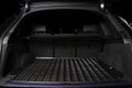 The big black empty trunk of SUV car with rubber mat and with le Royalty Free Stock Photo