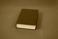 Big black hardcover closed book. Sepia photograph, image Royalty Free Stock Photo