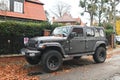 Big black high 4x4 offroad car Jeep Wrangler Sahara five door parked Royalty Free Stock Photo