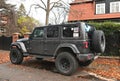 Big black high 4x4 offroad car Jeep Wrangler Sahara five door parked