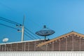 Big Black Satellite Dish on the roof with blue sky. Royalty Free Stock Photo