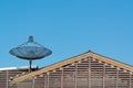 Big Black Satellite Dish on the roof with blue sky. Royalty Free Stock Photo