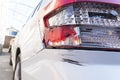 Big black scratch on rear bumper and broken taillight on white car due to car crash, Royalty Free Stock Photo