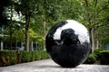 Big black sphere sculpture on the bank of River Th