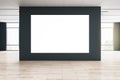 Big blank white poster on black wall in the center of empty eco style hall with big windows and wooden floor. Mockup Royalty Free Stock Photo