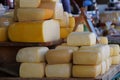 Big blocks of Cheese stacked on a table in a market Royalty Free Stock Photo