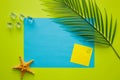 Big blue card with empty space for text. Little yellow card Tropical palm leaf, ice cubes, sea starfish, green background. Minimal