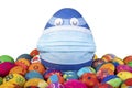 Big blue egg with face mask between painted easter eggs before white background Royalty Free Stock Photo