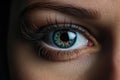 Big blue eye, long black eyelashes and eyebrow in pretty female face. Beautiful blue young woman eye, close up Royalty Free Stock Photo