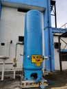 A big blue industrial receiver tank