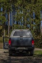 Big blue off-road car with white roof in color autumn forest in mountains Sumava