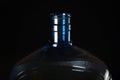 Top of big blue plastic bottle for water on black background close up Royalty Free Stock Photo