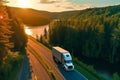 Big blue truck driving fast with a white trailer with blank space for text on a countryside road with other cars against