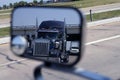 A big blue truck in the vehicle mirror Royalty Free Stock Photo