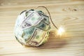 Bomb of money hundred dollar bills with a burning wick. Little time before the explosion. Concept of financial crisis Royalty Free Stock Photo