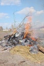 Big bonfire in the open air. A pile of ash from burnt boards and branches. Hot flame Royalty Free Stock Photo