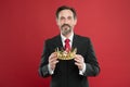 He is a big boss here. The old man or big boss. Proud boss. Big boss holding jewelry crown on red background. Mature Royalty Free Stock Photo