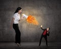 Big boss yelling to her employee with megaphone on fire Royalty Free Stock Photo