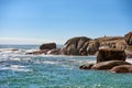 Big boulders, rocks and stones at the beach, sea and ocean against a clear blue sky background with copy space. Calm Royalty Free Stock Photo