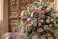 Big bouquets of colorful flowers. Luxury wedding floral decorations at the entrance of Ostuni church. Royalty Free Stock Photo