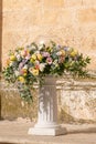 Big bouquets of colorful flowers. Luxury wedding floral decorations at the entrance of Ostuni church. Royalty Free Stock Photo