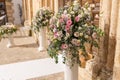 Big bouquets of colorful flowers. Luxury wedding floral decorations at the entrance of Ostuni church. Royalty Free Stock Photo