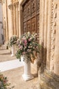 Big bouquets of colorful flowers. Luxury wedding floral decorations at the entrance of Ostuni church. Royalty Free Stock Photo