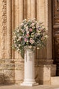 Big bouquets of colorful flowers. Luxury wedding floral decorations at the entrance of Ostuni church. Royalty Free Stock Photo