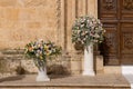 Big bouquets of colorful flowers. Luxury wedding floral decorations at the entrance of Ostuni church. Royalty Free Stock Photo