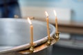 Big bowl of water for the baptism of a baby with wax candles. Orthodoxy. Greek Catholics. macro Royalty Free Stock Photo