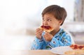 Big boys take big bites. A cute little boy eating breakfast. Royalty Free Stock Photo