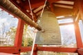 Big brass Buddhist bell and knock bell timber of Japanese temple in red pavilion on bright blue sky Royalty Free Stock Photo