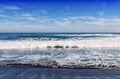 Big breaking Ocean wave on a black sandy beach on Pacific ocean. Royalty Free Stock Photo