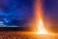 Big bright bonfire on sandy beach at night Royalty Free Stock Photo