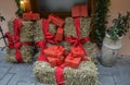 Big bright Christmas presents red boxes with craft wrapped gift lie on the hay, New Year presents Royalty Free Stock Photo