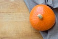 Big Bright Orange Pumpkin Grey Linen Towel on Aged Wood Background. Copy Space for Text. Thanksgiving Harvest Autumn Fall Royalty Free Stock Photo