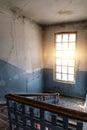 Big bright window and stairs in old dirty abandoned building Royalty Free Stock Photo
