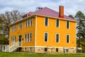 Big Bright Yellow Colonial Style House