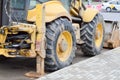 Big bright yellow powerful industrial heavy excavator tractor, bulldozer, specialized construction equipment for road repair Royalty Free Stock Photo