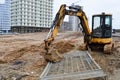 Big bright yellow powerful industrial heavy excavator tractor, bulldozer, specialized construction equipment for road repair Royalty Free Stock Photo