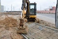 Big bright yellow powerful industrial heavy excavator tractor, bulldozer, specialized construction equipment for road repair Royalty Free Stock Photo