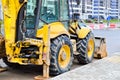 Big bright yellow powerful industrial heavy excavator tractor, bulldozer, specialized construction equipment for road repair Royalty Free Stock Photo