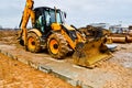 Big bright yellow powerful industrial heavy excavator tractor, bulldozer, specialized construction equipment for road repair Royalty Free Stock Photo