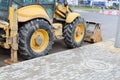 Big bright yellow powerful industrial heavy excavator tractor, bulldozer, specialized construction equipment for road repair Royalty Free Stock Photo