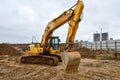 Big bright yellow powerful industrial heavy excavator tractor, bulldozer, specialized construction equipment for road repair Royalty Free Stock Photo